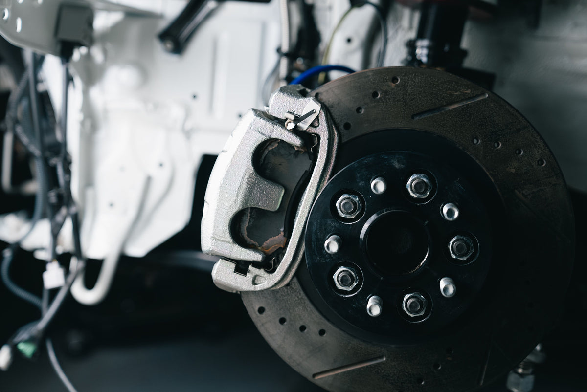 Close-up of a car brake caliper and rotor